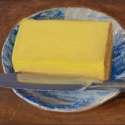 251201-a-piece-of-butter-and-a-nife-on-a-blue-whtie-saucer-7x5